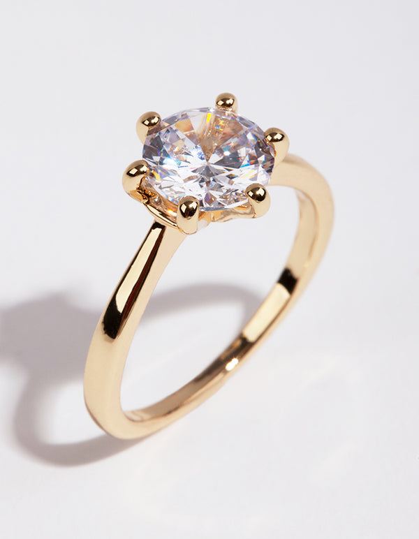 Showcasing a gold plated ring with round cubic zirconia featuring clear accents front view