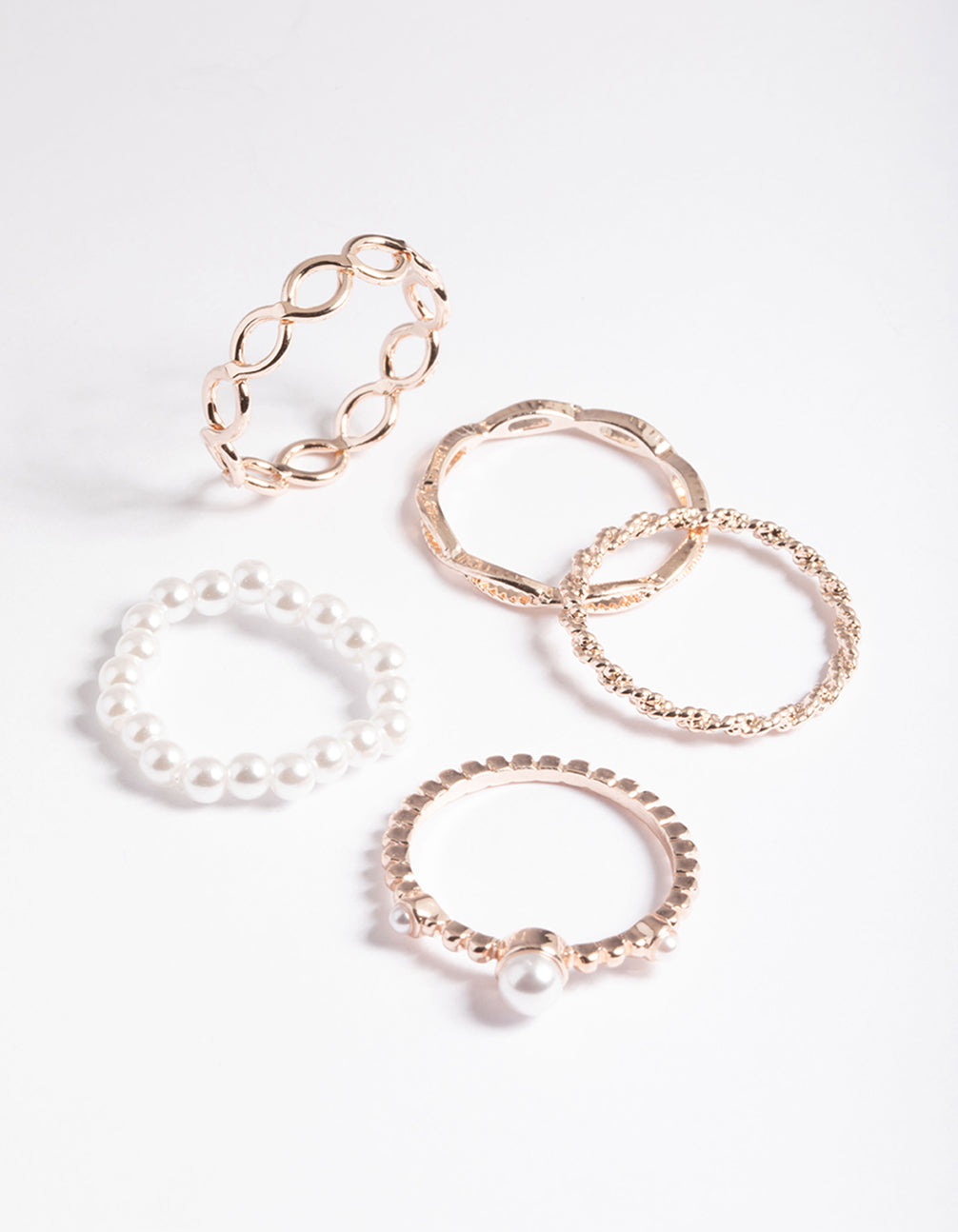 This set features pearl and twist rings in dainty rose gold front view