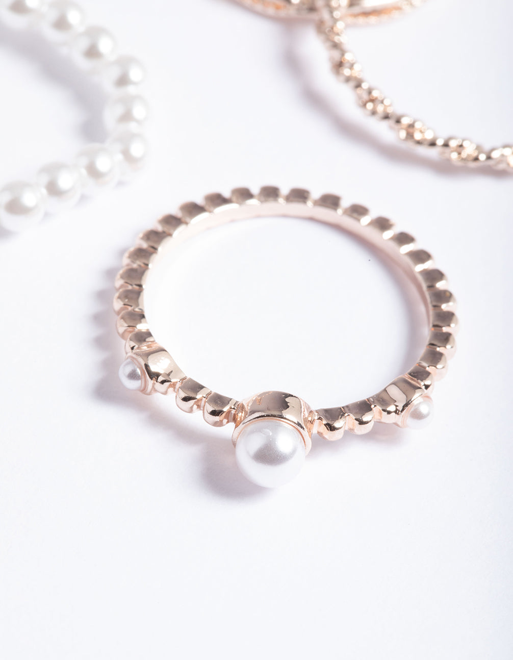 Highlighting pearl and twist details, these rose gold dainty rings feature side detail view