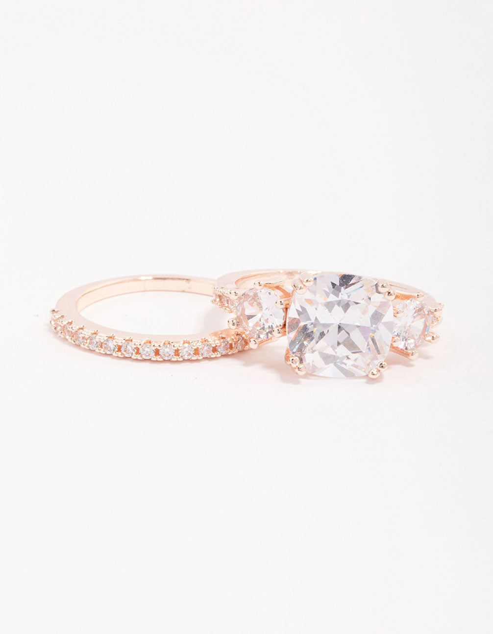 Elegant rose gold triple stone ring set featuring cubic zirconia side detail view