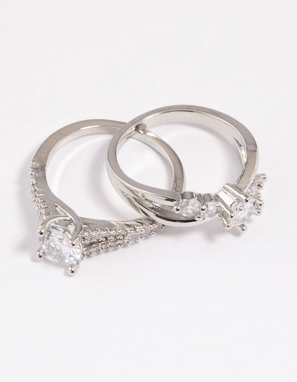 Presenting a diagonal cubic zirconia engagement ring pack with dainty design close up view