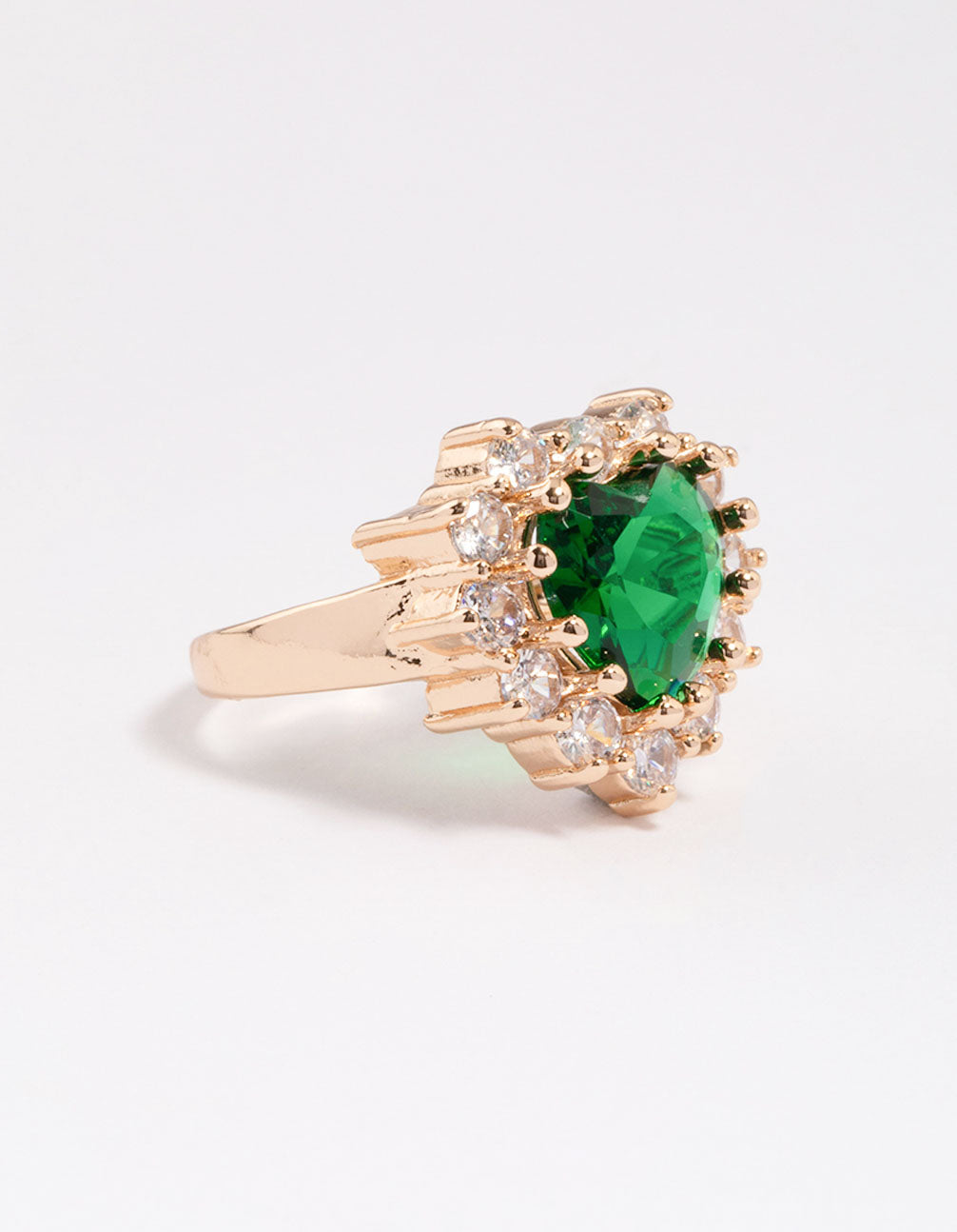 Showcasing a dainty heart ring in gold with lime green stone side detail view