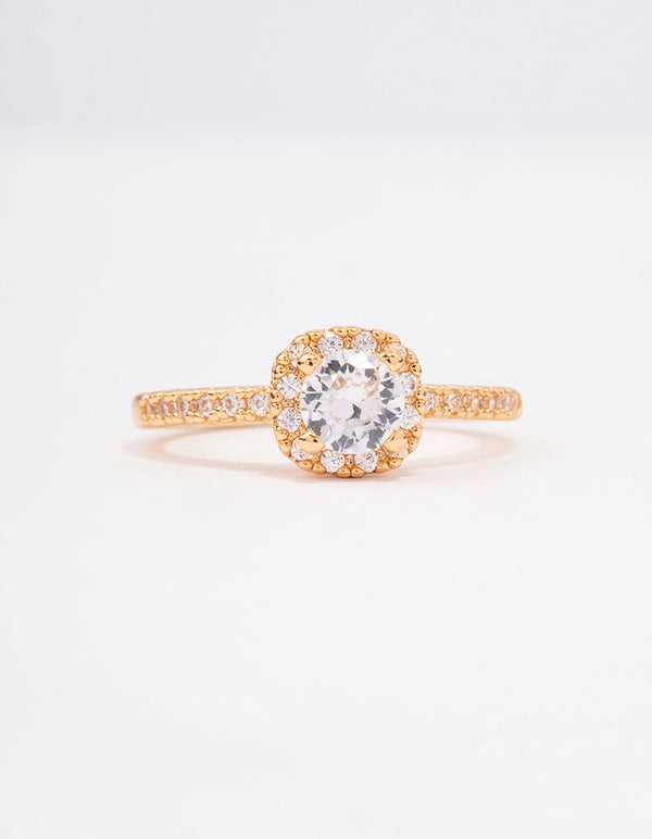 Featuring a gold plated mini cushion cubic zirconia engagement ring with halo setting and stone accents close up view