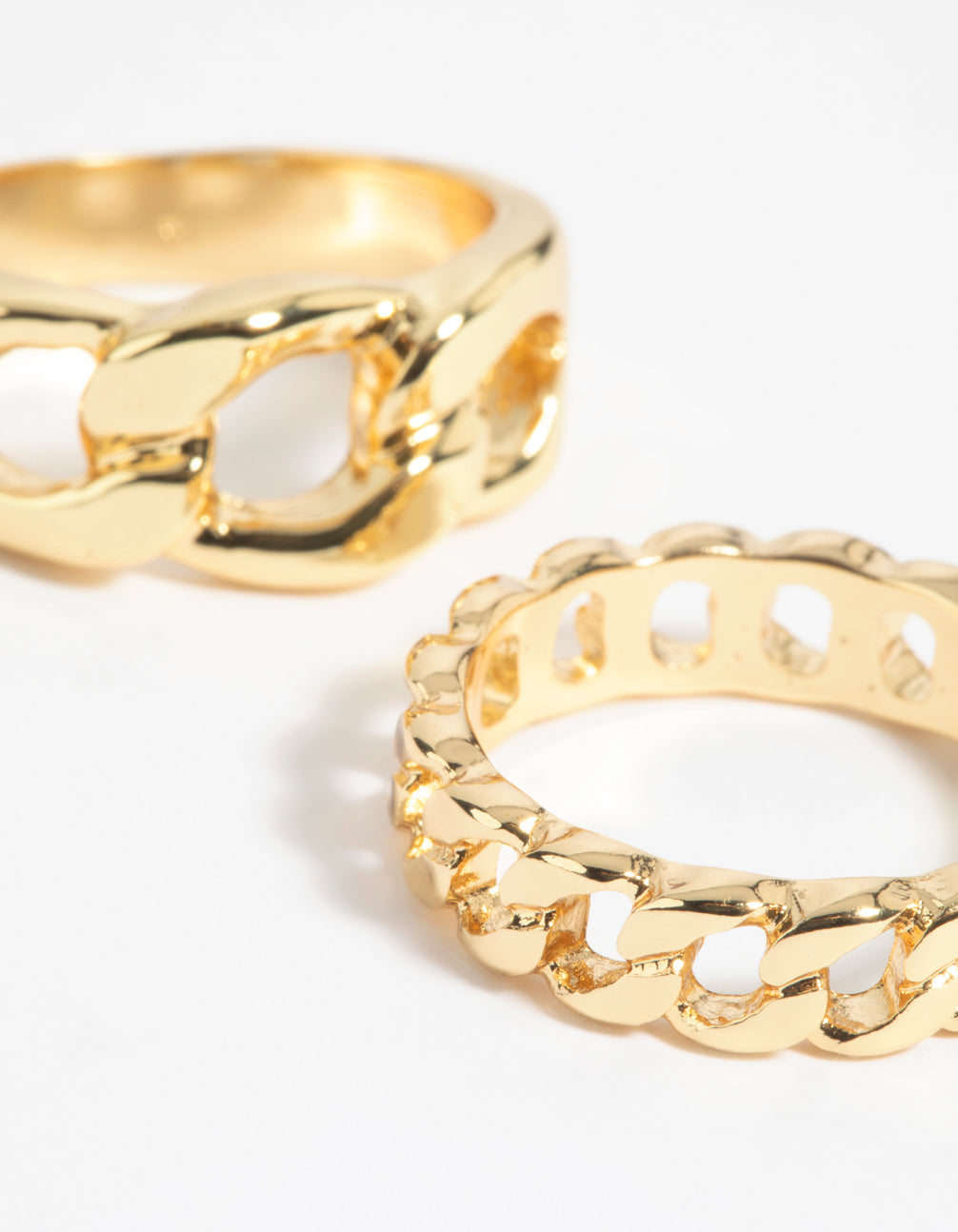 Highlighting a gold chain ring stack pack close up view