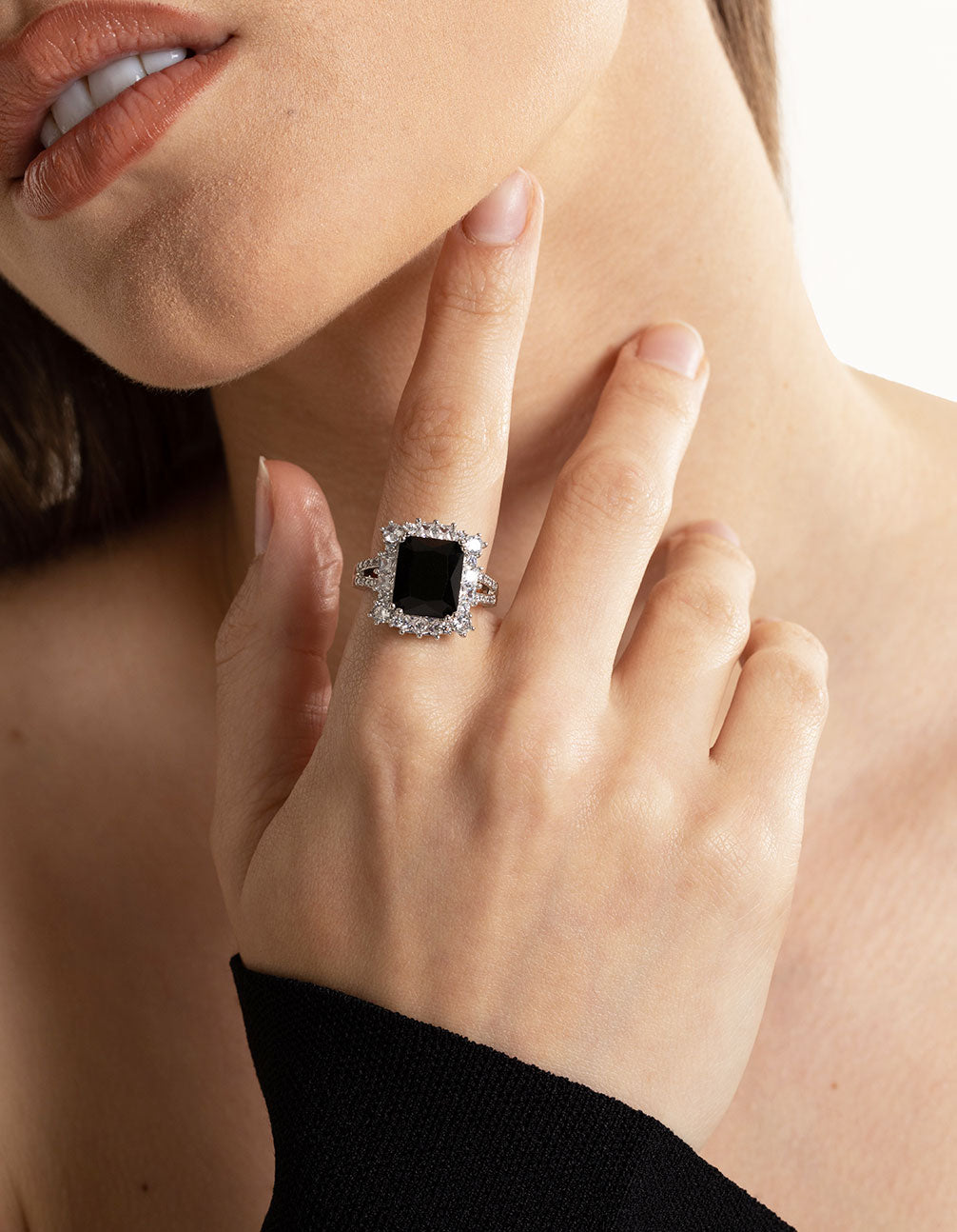 Elegant cubic zirconia ring featuring emerald cut stone in black and silver on finger view