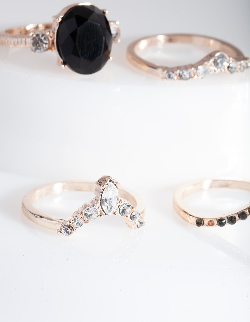 Discover rose gold black stone ring stack in statement style close up view