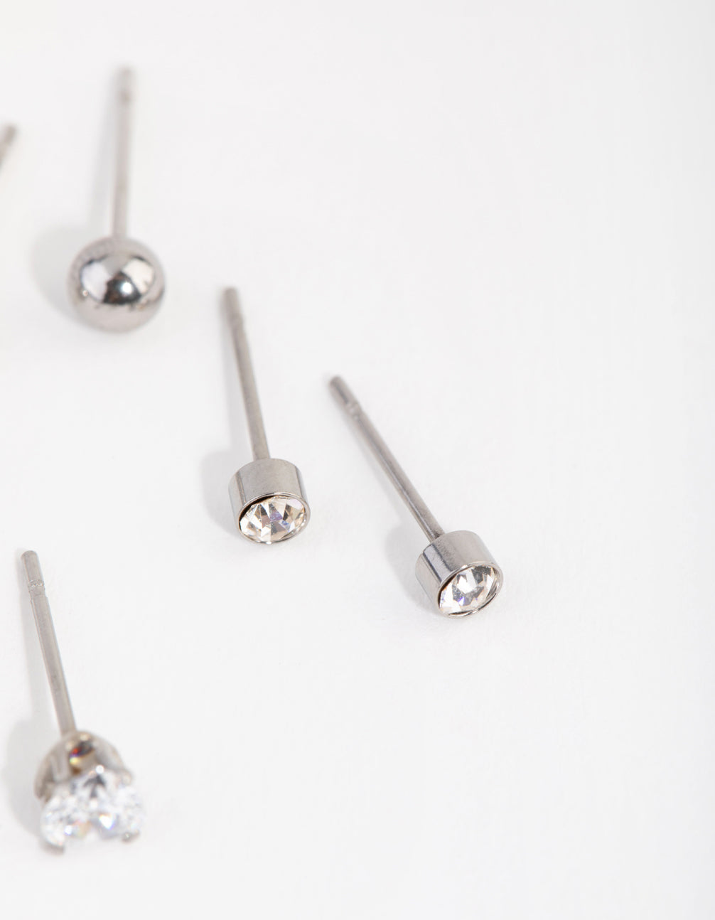 Featuring dainty surgical steel love stud earrings in a 3-pack post detail view
