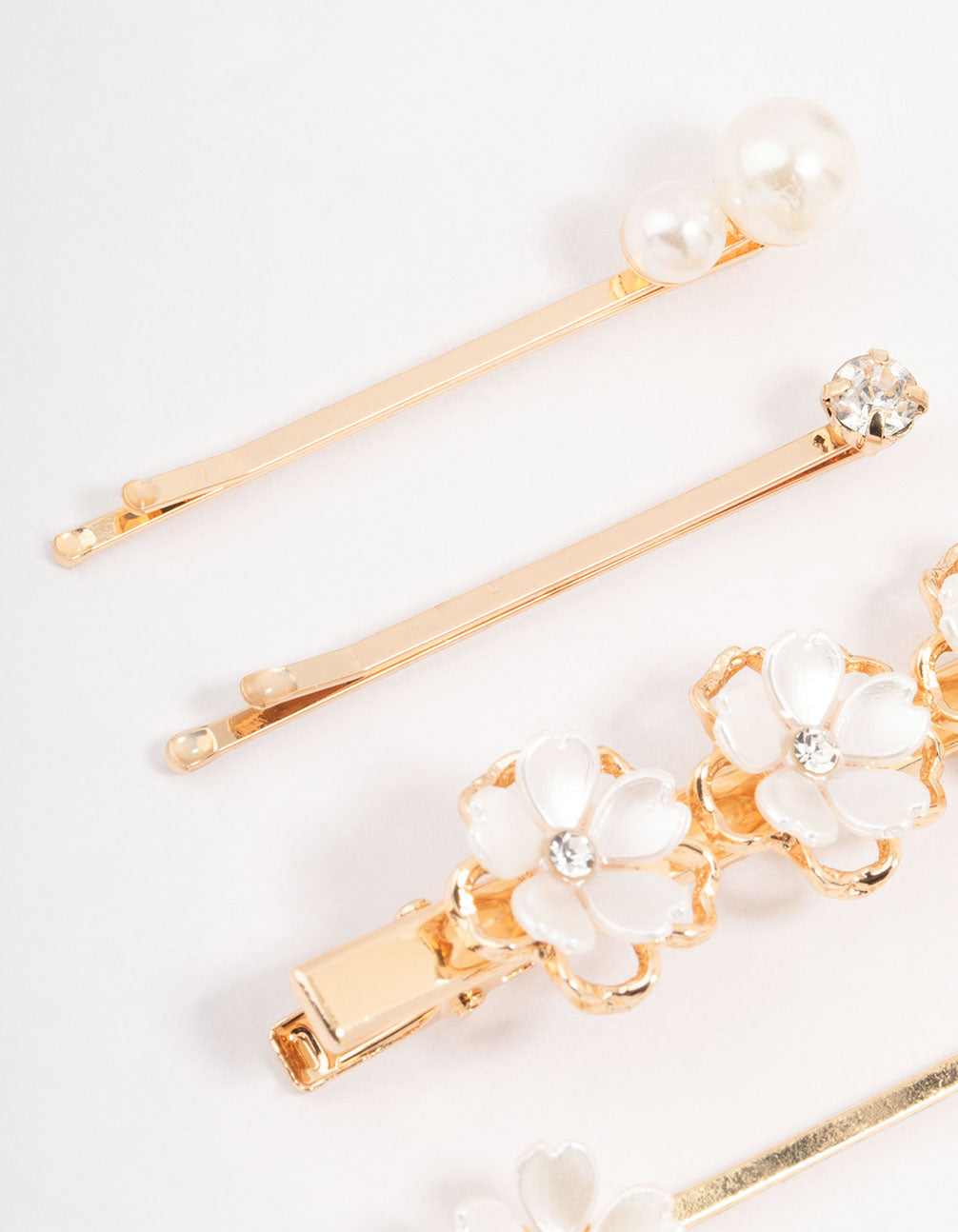 Beautifully crafted mixed gold pearl and flower hair clips featuring ivory in side view