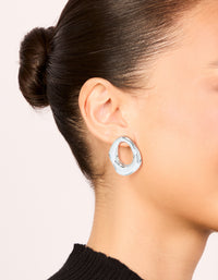 Featuring molten open circle stud earrings in silver plated metal on ear view - link has visual effect only