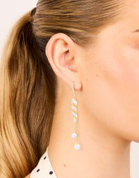 Showcasing gold plated cubic zirconia pearl and leaf drop hook earrings on ear view - link has visual effect only