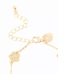 Highlighting the gold plated alternating small and medium flower bracelet with charm elements in white closure detail view - link has visual effect only
