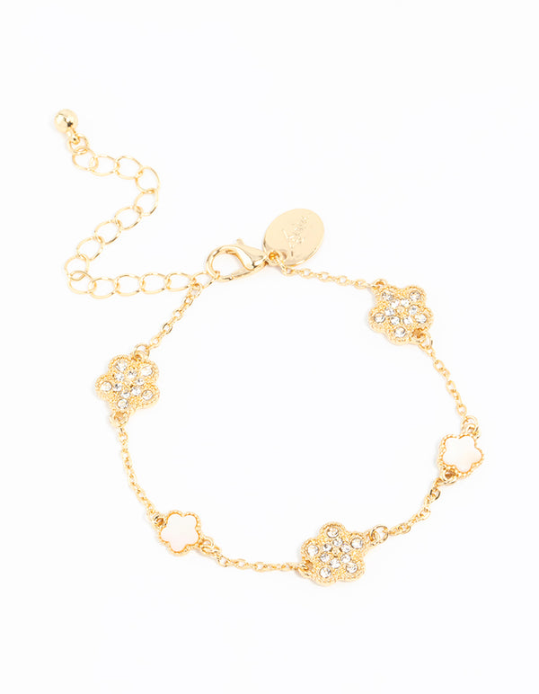 Showcasing a gold plated alternating small and medium flower bracelet featuring charm details in white front view