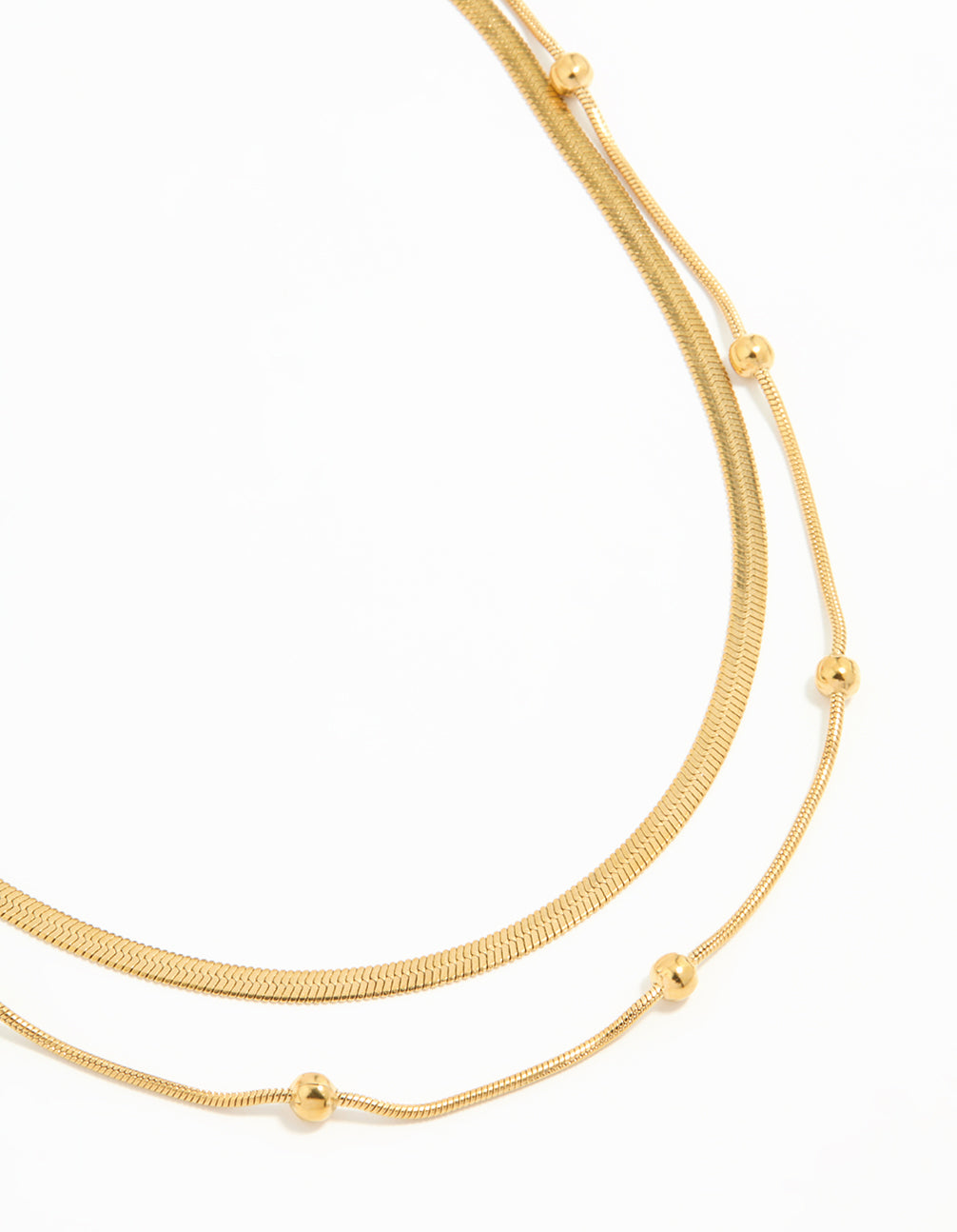 Showcasing a waterproof gold plated stainless steel ball chain layered necklace close up view
