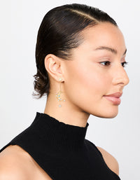 Featuring gold plated cubic zirconia moon drop earrings with celestial and pearl details on model view - link has visual effect only