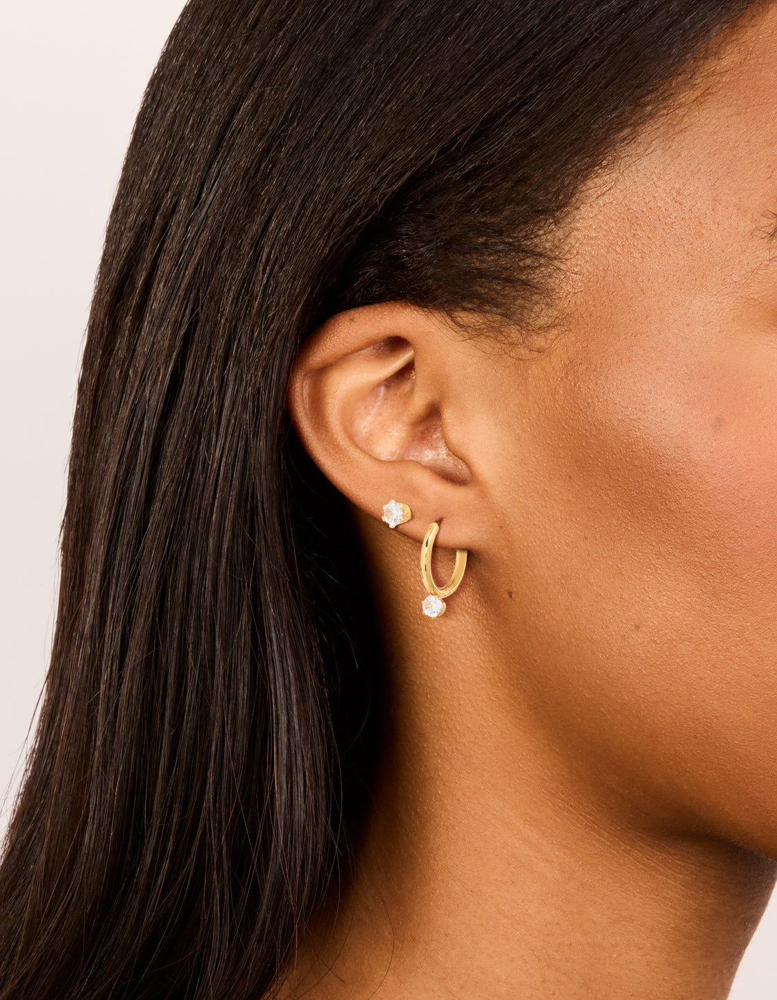 Showcase your style with dainty waterproof cubic zirconia stainless steel mini earrings in a 2-pack on ear view