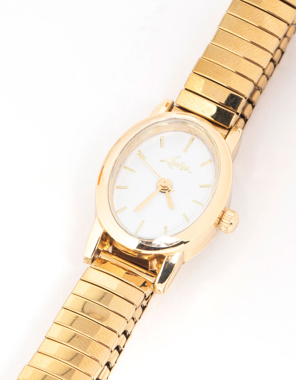 Discover a mini oval stretch watch with white dial with stone look, round shape, women's casual style, link band strap in gold color, analog type watch face detail view