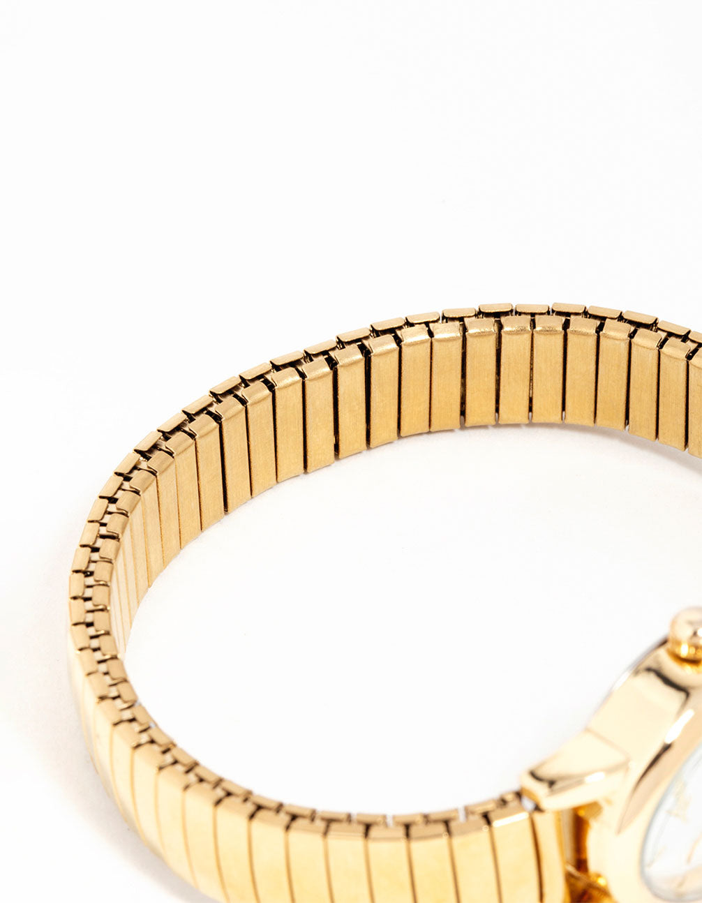 Elegant mini oval stretch watch with white dial with stone look, round shape, women's casual style, link band strap in gold color, analog type front view
