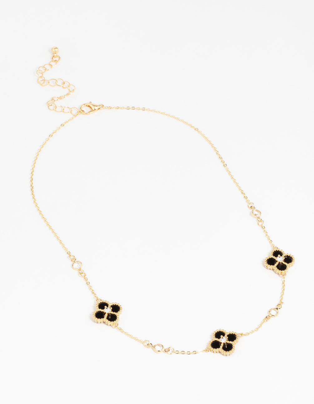 Featuring gold plated cubic zirconia black flower pendant necklace with floral details and crystal elements front view