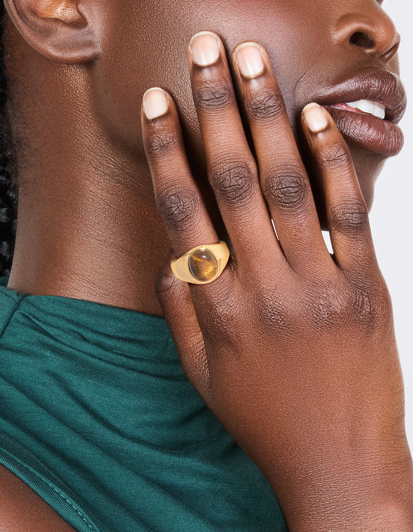 Experience a waterproof gold plated stainless steel statement stone ring with brown cabochon on finger view