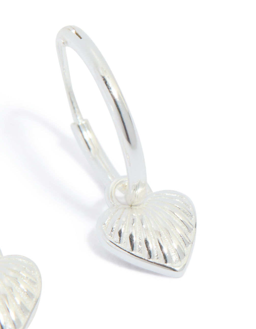 Presenting sterling silver heart huggie earrings in silver post detail view