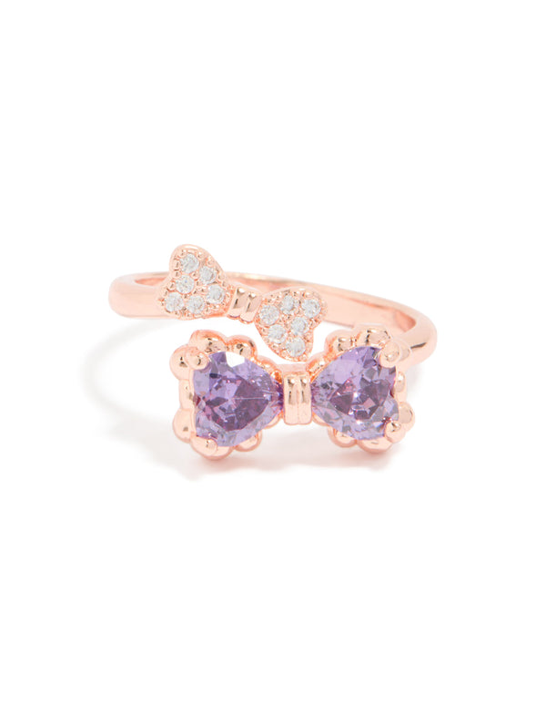 Featuring a charming bow design, this rose gold cubic zirconia ring displays the delicate violet stones and band structure close up view