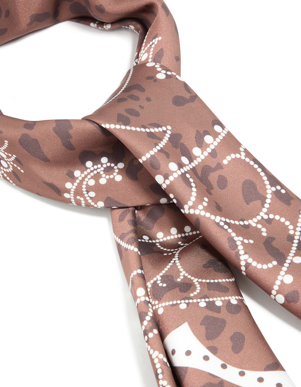 Crafted from fabric, a western scarf featuring leopard print in tan and sienna detail view