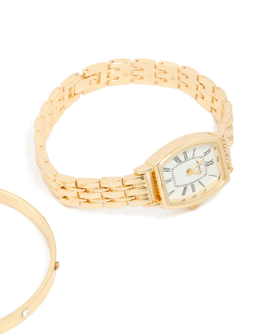 Crafted with precision a gold diamante roman numeral analog watch and wrist cuff set featuring white dial for women with link band for formal occasions in a statement style watch face detail view