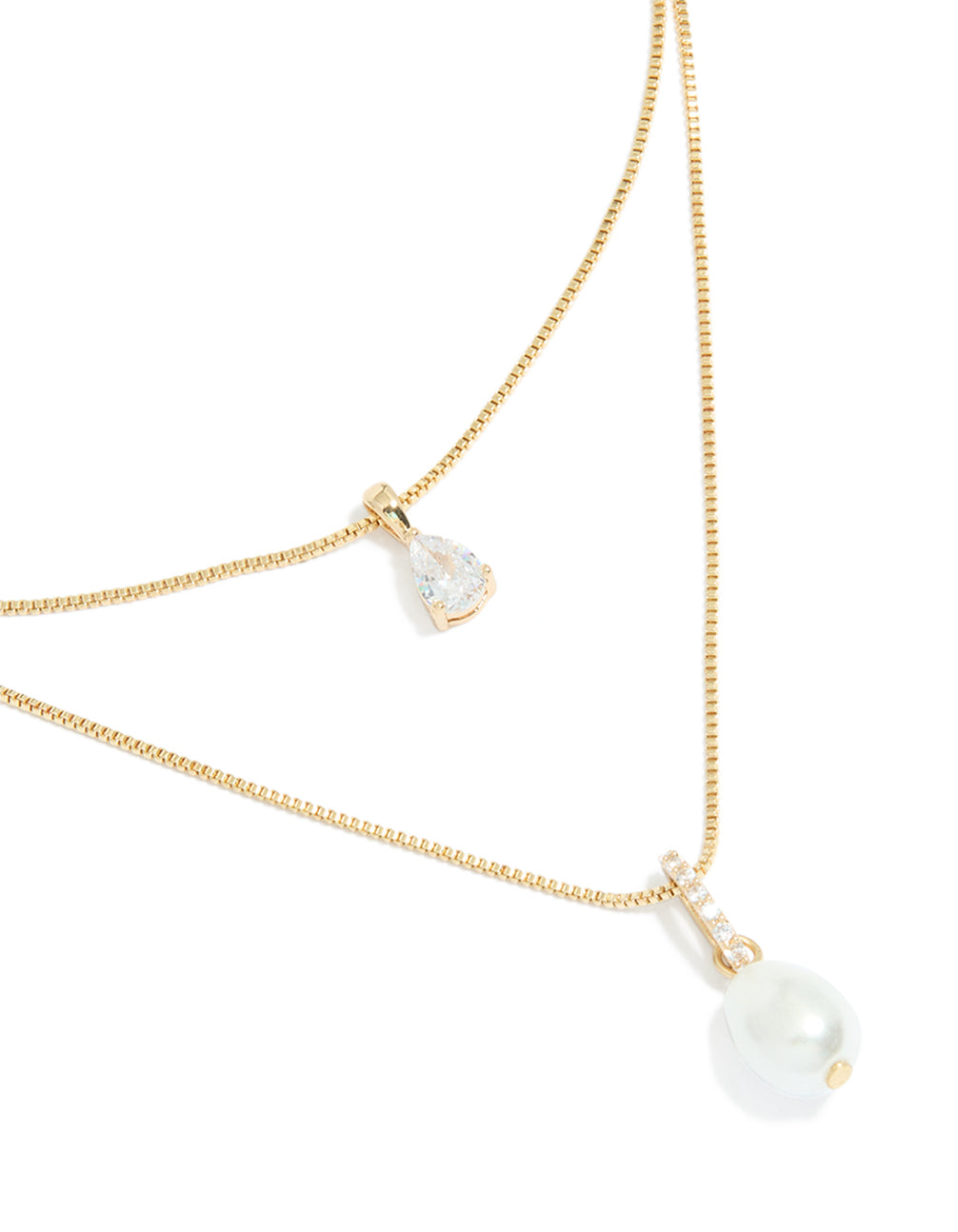 Showcasing a gold plated cubic zirconia pearl layered necklace close up view