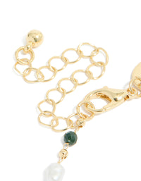 Presenting a gold plated bracelet featuring green beads and pearls closure detail view - link has visual effect only