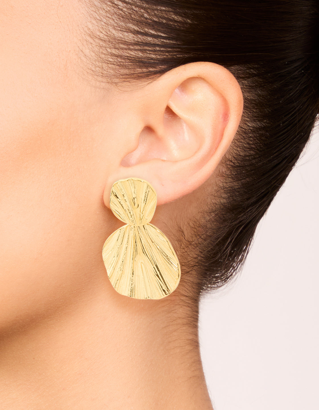 Elegant waterproof gold plated stainless steel double textured drop earrings in statement style on ear view