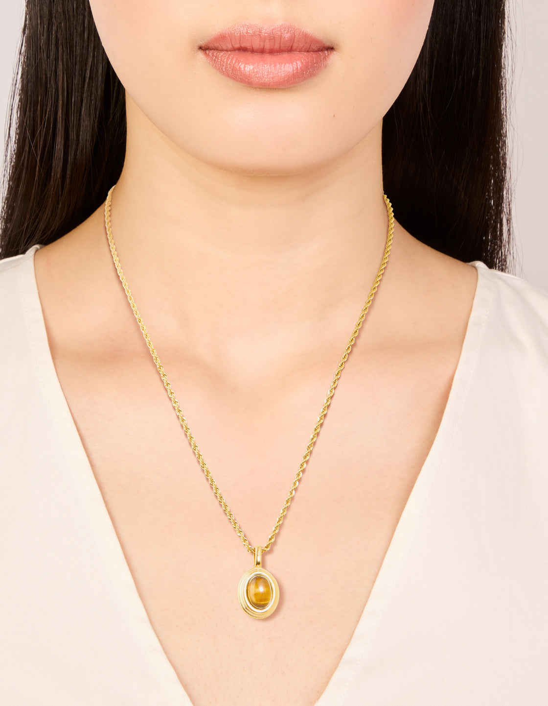 Presenting a waterproof gold plated stainless steel tiger's eye semi precious stone pendant necklace on neck view