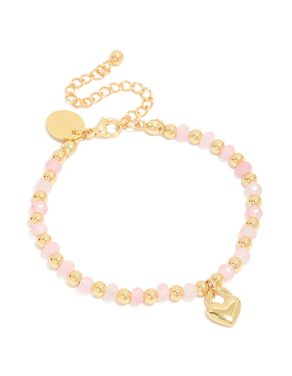 Showcasing a waterproof gold plated stainless steel bracelet with pink beads and heart charm in light pink front view