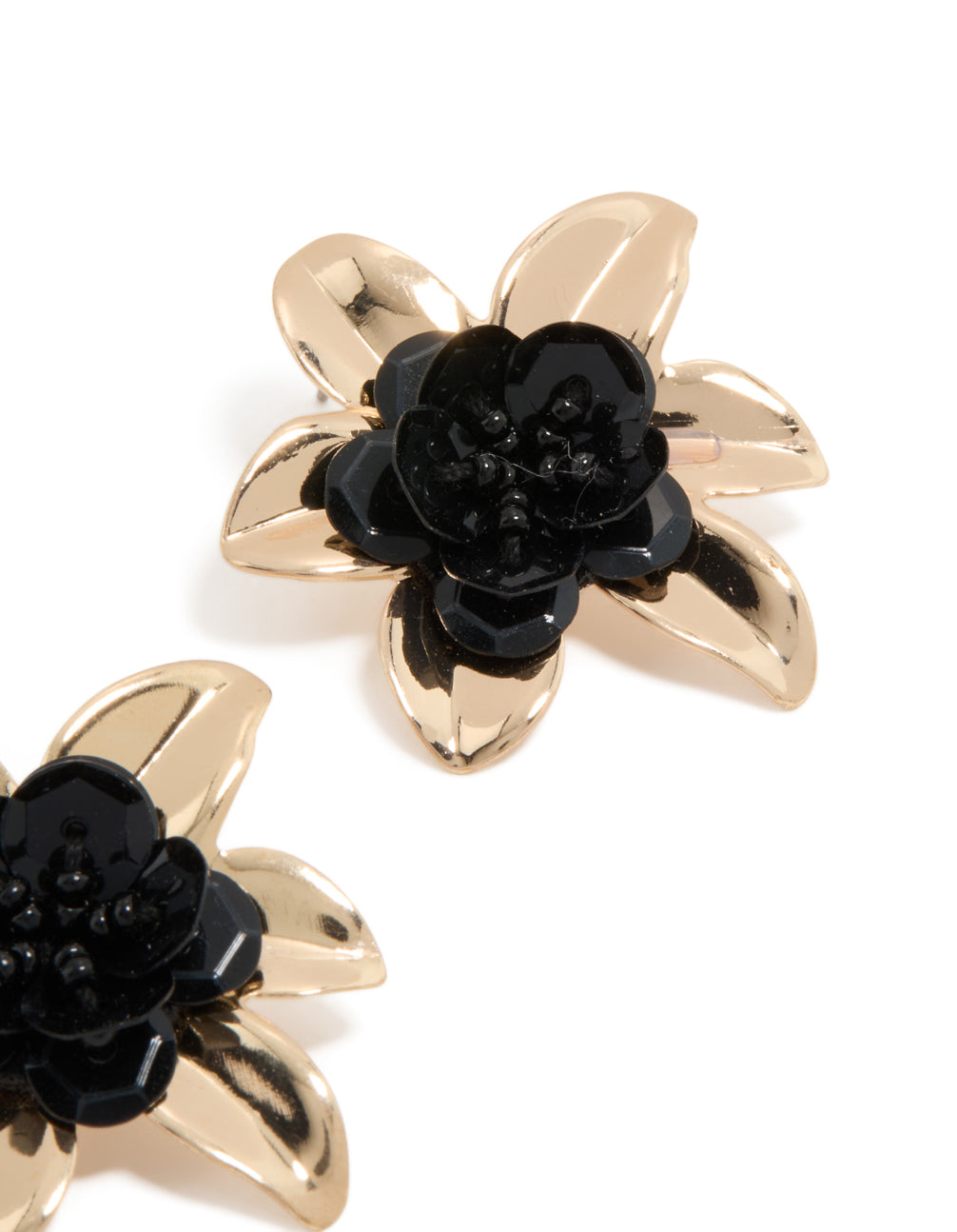 Showcasing statement stud earrings with beaded floral design in gold and black close up view