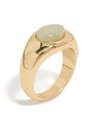 Designed with gold plated material, this ring showcases a pale green oval stone in a statement style close up view - link has visual effect only