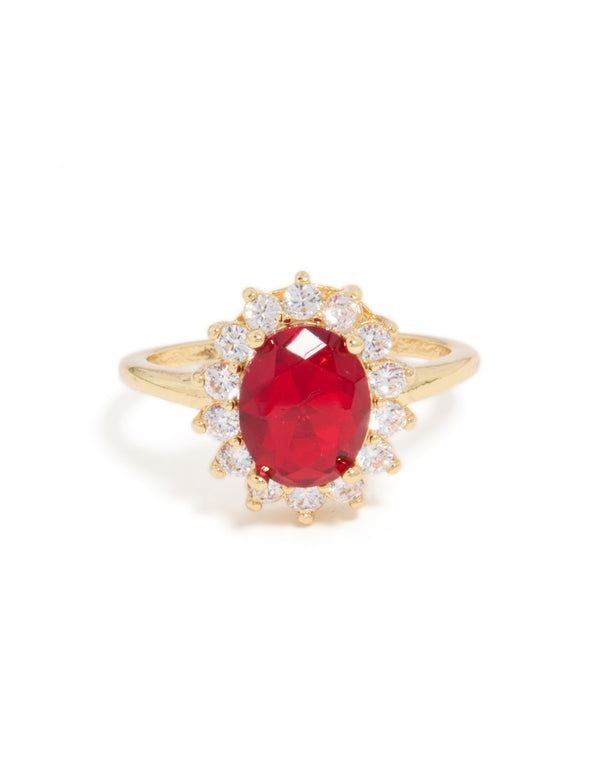 Dazzling statement ring featuring oval cut red cubic zirconia with clear halo stones in gold plated metal close up view