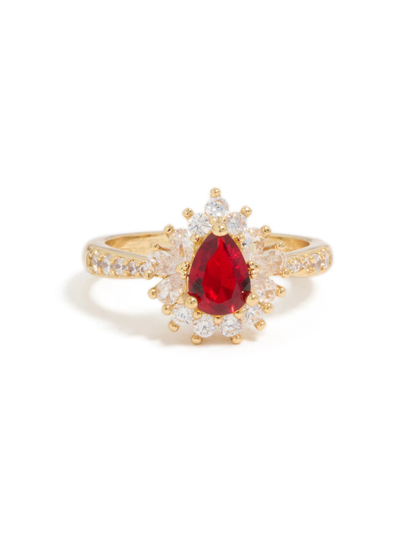 A gold plated gleaming red cubic zirconia pear ring featuring crystal and clear stones close up view