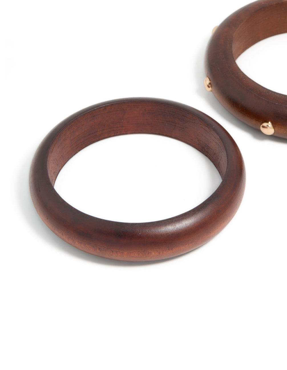 Showcasing studded wooden bangles in a 2-pack with saddlebrown and gold finishes, designed in statement chunky style in close up view
