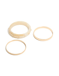 Showcasing a 3-pack of studded acrylic bangles in gold and cream tones front view - link has visual effect only