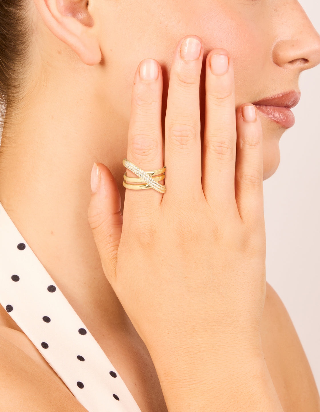 Beautifully crafted waterproof stainless steel criss cross pave ring in statement style featuring cubic zirconia on finger view