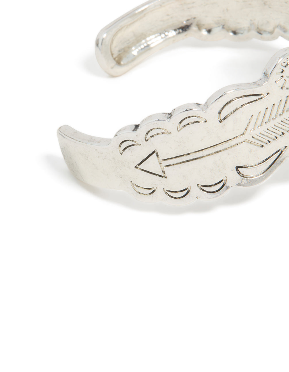 Crafted with silver boho heart wrist cuff featuring floral detailing and statement design in close up view