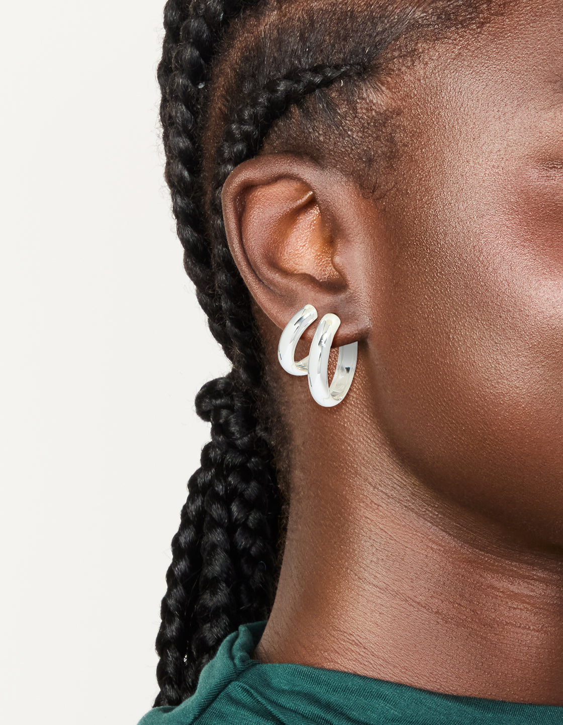 Showcasing these chunky waterproof stainless steel thick hoop earrings in silver in a 2-pack on ear view