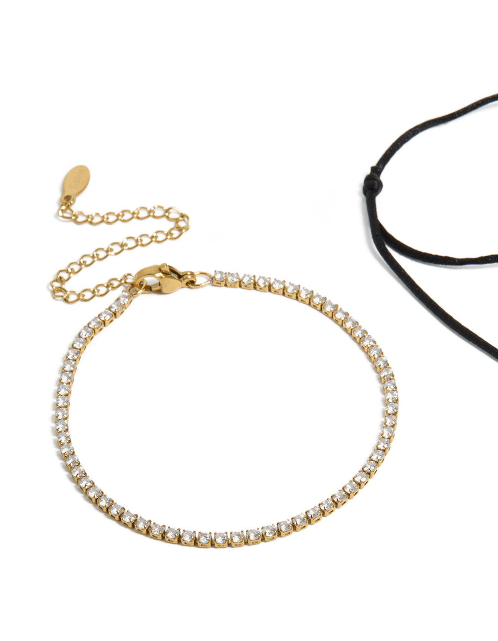 Beautiful waterproof tennis bracelet set with gold plated stainless steel featuring cubic zirconia and black cord in a statement style in closure detail view