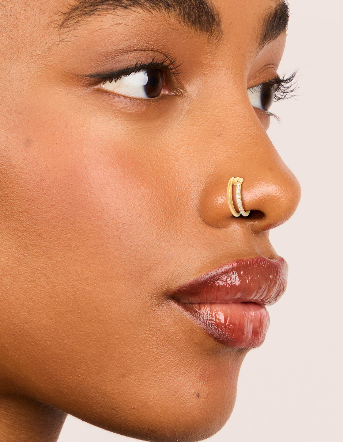 Showcasing gold plated surgical steel nose rings with cubic zirconia in a 2-pack nose view