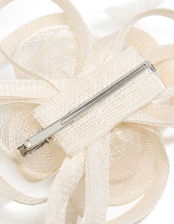 Elegantly crafted white sinamay fabric swirl hair clip featuring floral and feather in ivory detail view
