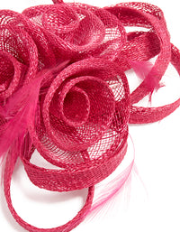 Crafted from crimson sinamay fabric, this swirl and feather hair clip features a floral design, detail view - link has visual effect only