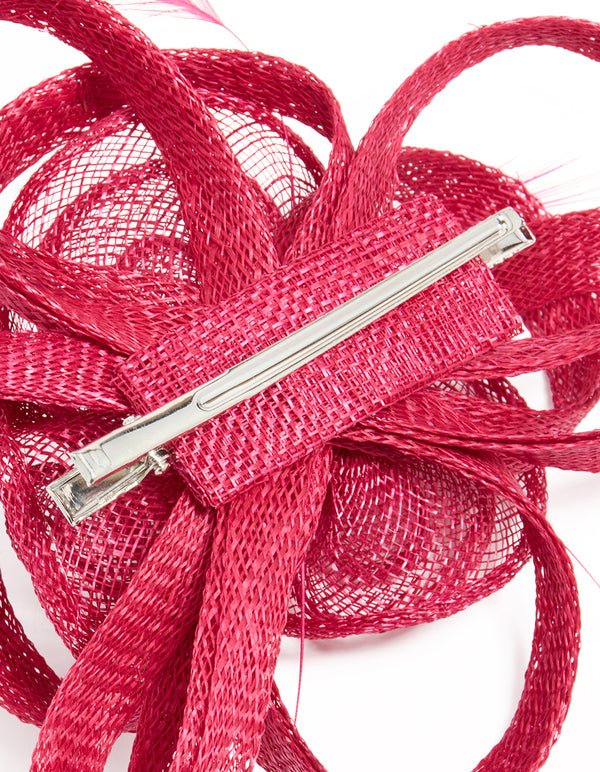 Crafted from crimson sinamay fabric, this swirl and feather hair clip features a floral design, detail view