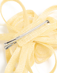 Crafted with yellow sinamay fabric, this swirl and feather hair clip features a floral design, detail view - link has visual effect only