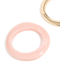 Showcasing a 2-pack of chunky acrylic bangles in gold and pink close up view - link has visual effect only