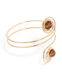 Showcasing a gold swirl and brown stones arm cuff with statement design front view - link has visual effect only