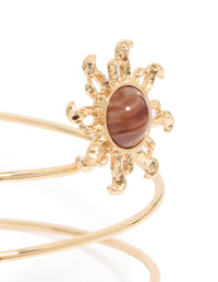 Gold sun and swirl arm cuff with celestial design close up view - link has visual effect only
